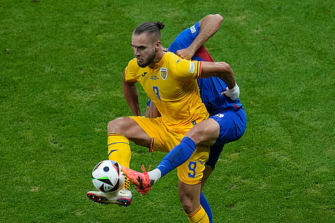 George Puscas and David Hancko battle for the ball